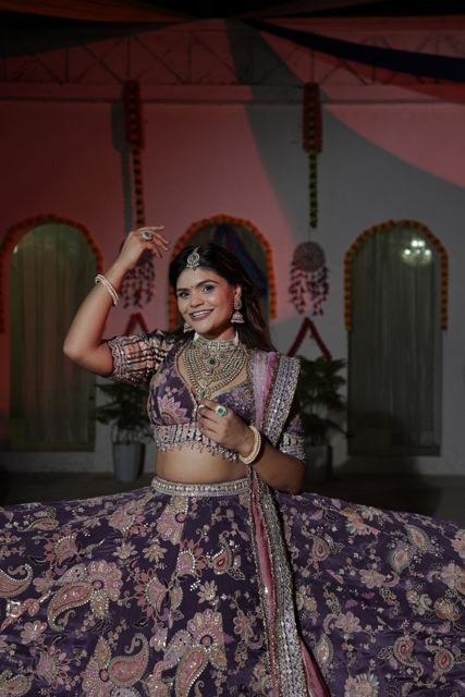 Festive night performance in a purple lehenga